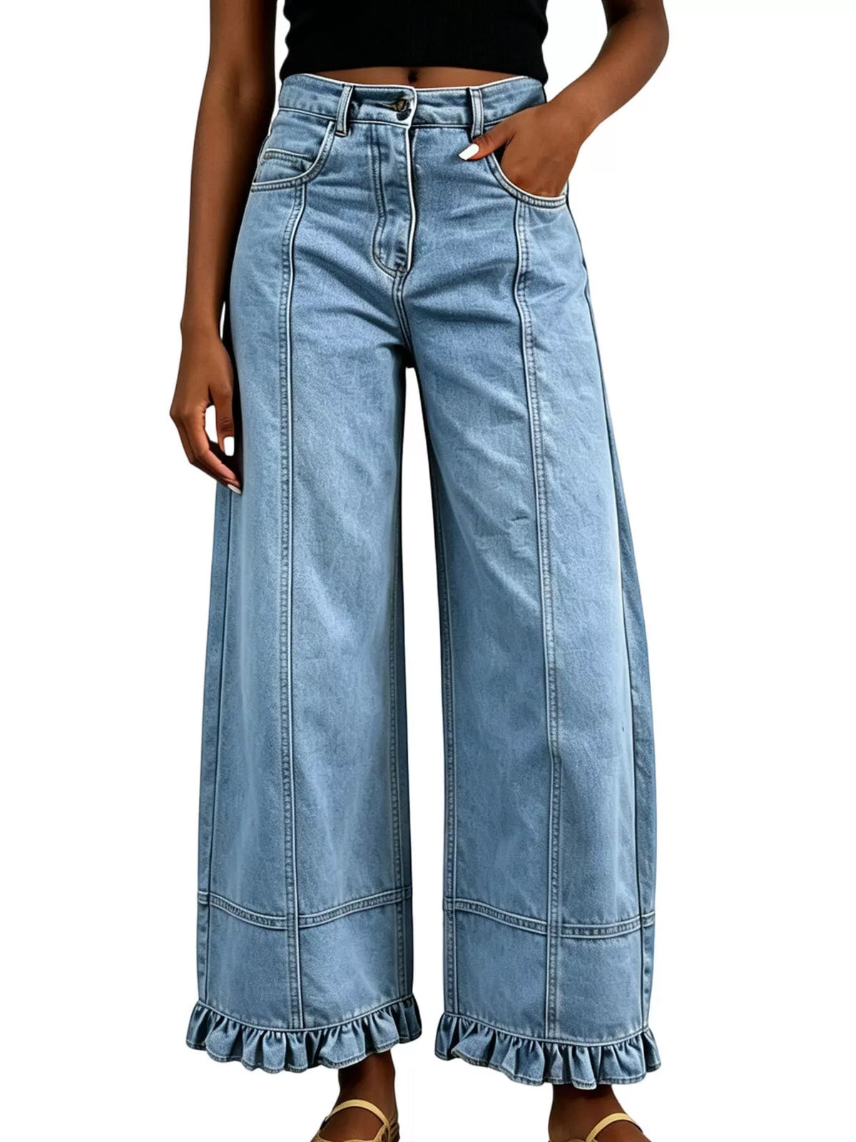 A person wearing light-wash blue wide-leg denim jeans with a ruffled hem, shown from the waist down against a plain white background.