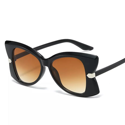 Black cat-eye sunglasses with gradient brown lenses and small silver metal accents on the temples, shown on a clean white background.