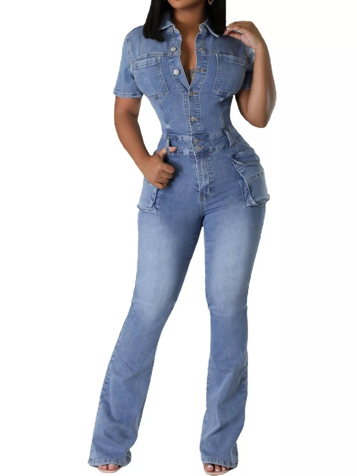 A woman modeling a light blue denim one-piece jumpsuit with short sleeves, a button-up front, and a fitted silhouette with a flared leg, shown against a plain white background.
