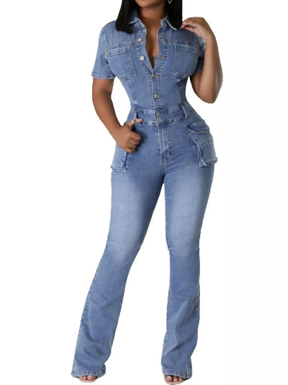 A woman modeling a light blue denim one-piece jumpsuit with short sleeves, a button-up front, and a fitted silhouette with a flared leg, shown against a plain white background.