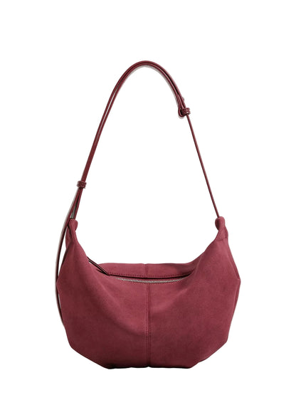A burgundy suede hobo shoulder bag with a single adjustable strap, displayed against a clean white background.