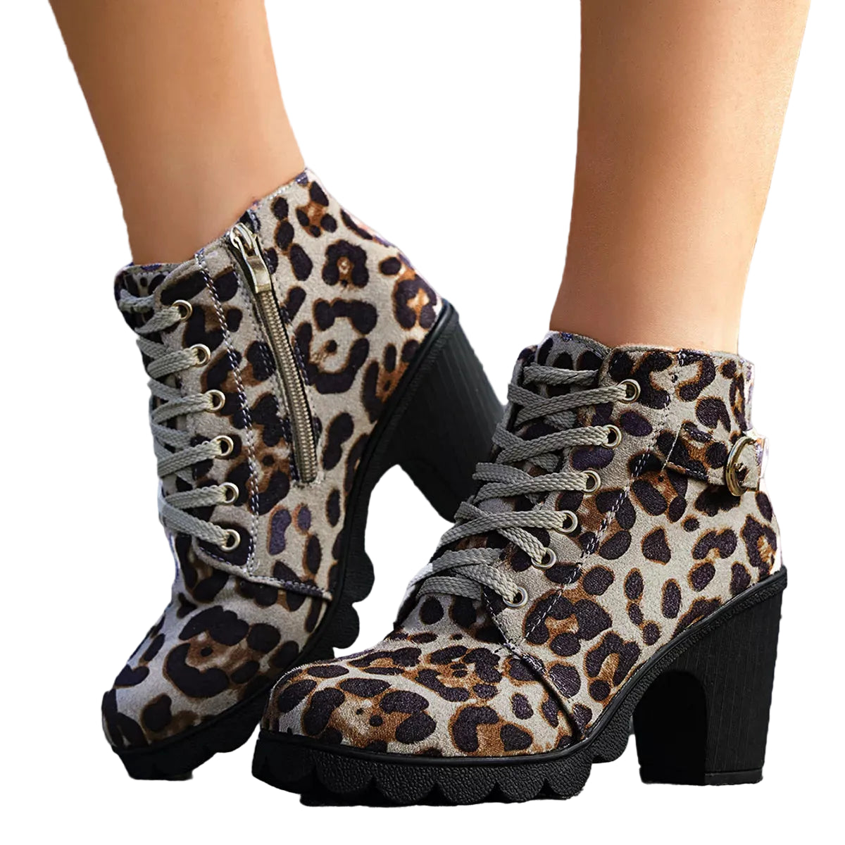 Leopard print boots with black soles worn by a person on a stone surface.
