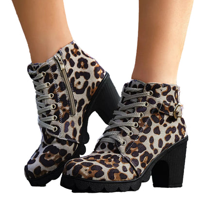 Leopard print boots with black soles worn by a person on a stone surface.
