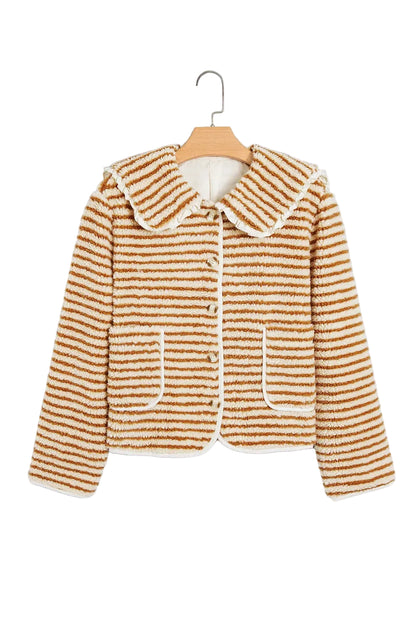 A cropped, long-sleeve textured jacket with horizontal brown and cream stripes, featuring a large Peter Pan collar, button-front closure, and front patch pockets, hanging on a wooden hanger against a light gray background.