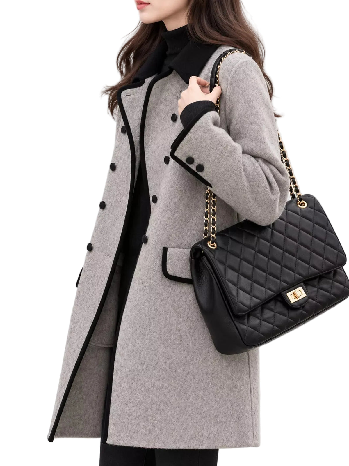 A woman wearing a light gray double-breasted coat with black trim and buttons, paired with a black turtleneck and carrying a black quilted shoulder bag with gold chain straps.