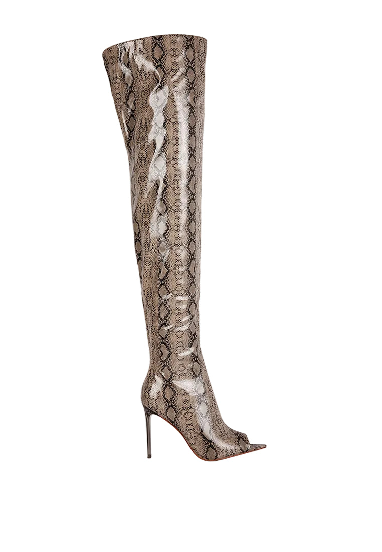 A single over-the-knee high-heeled boot with a glossy snakeskin pattern in shades of taupe, brown, and beige, shown from a side profile on a light gray background.