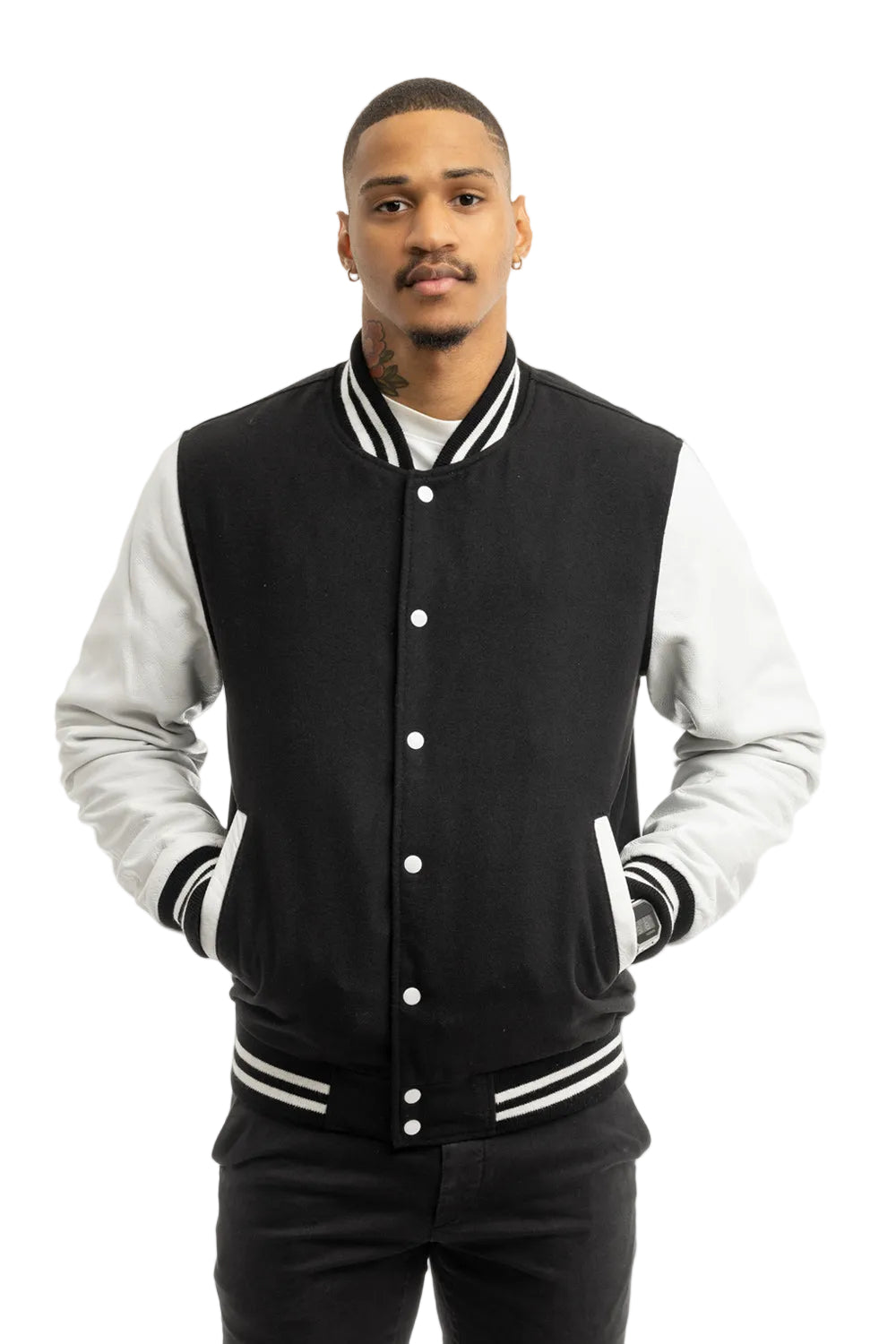 Man wearing a black and white varsity jacket on a white background
