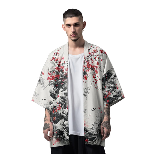 Man wearing a kimono-style garment with floral and wave design on a plain background