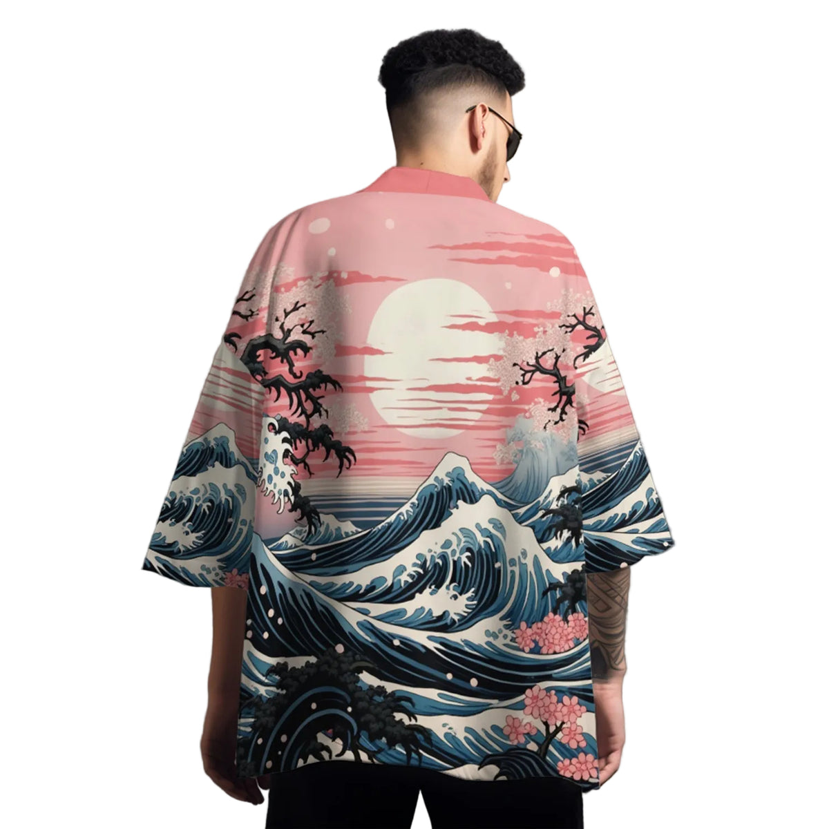 Person wearing a kimono-style shirt with wave and moon design on a gray background