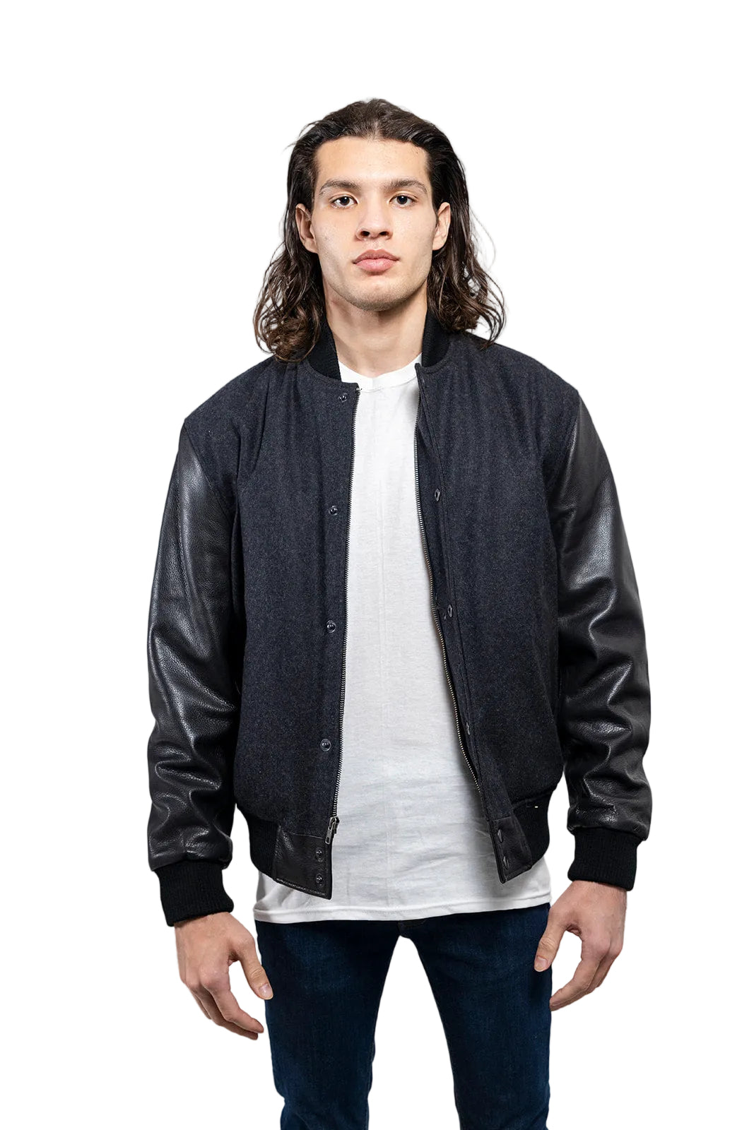 Man wearing a black leather bomber jacket over a white shirt on a gray background