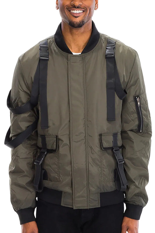 Man wearing a green bomber jacket with black straps on a white background