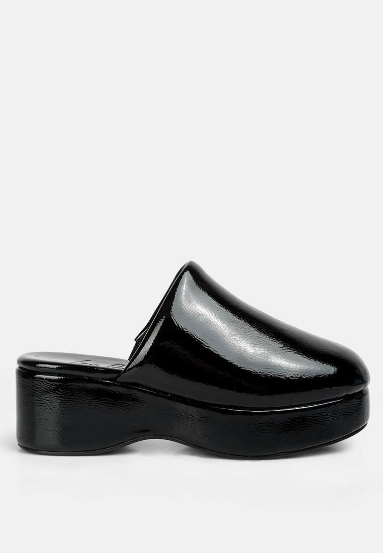 Black patent leather clog shoe on a white background