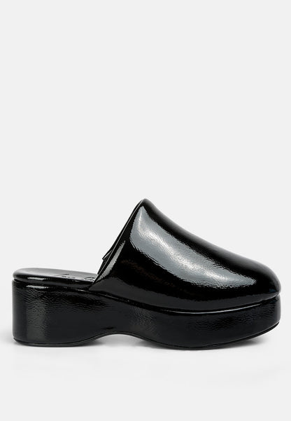 Black patent leather clog shoe on a white background