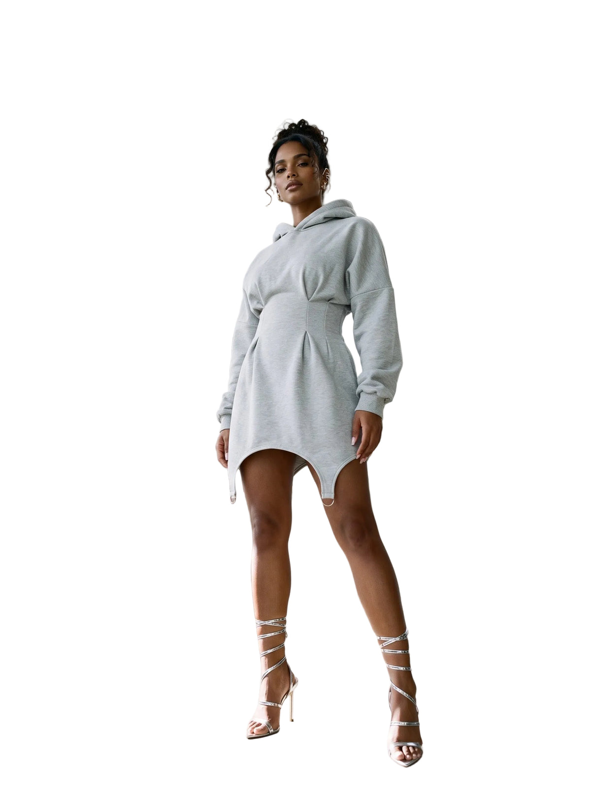 A woman models a light gray oversized mini hoodie dress in a modern concrete architectural setting with curved walkways and columns.