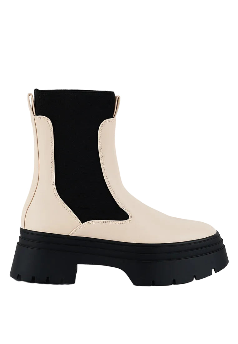 Black and beige Chelsea boot on a white background
