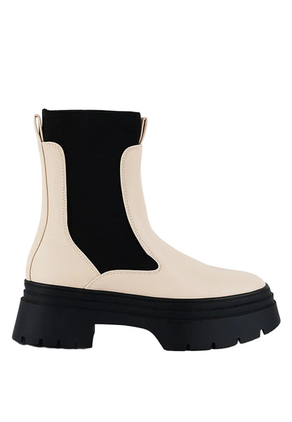 Black and beige Chelsea boot on a white background