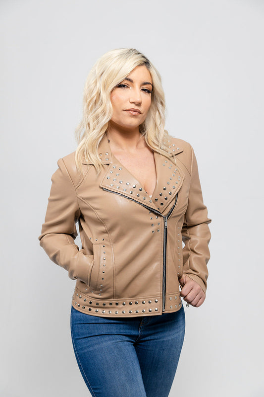 Woman wearing a beige leather jacket with studded details on a white background