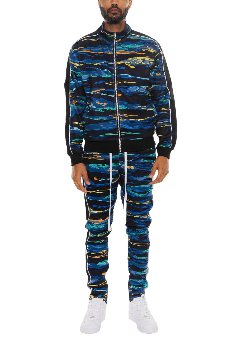 Person wearing a blue and black patterned tracksuit on a white background
