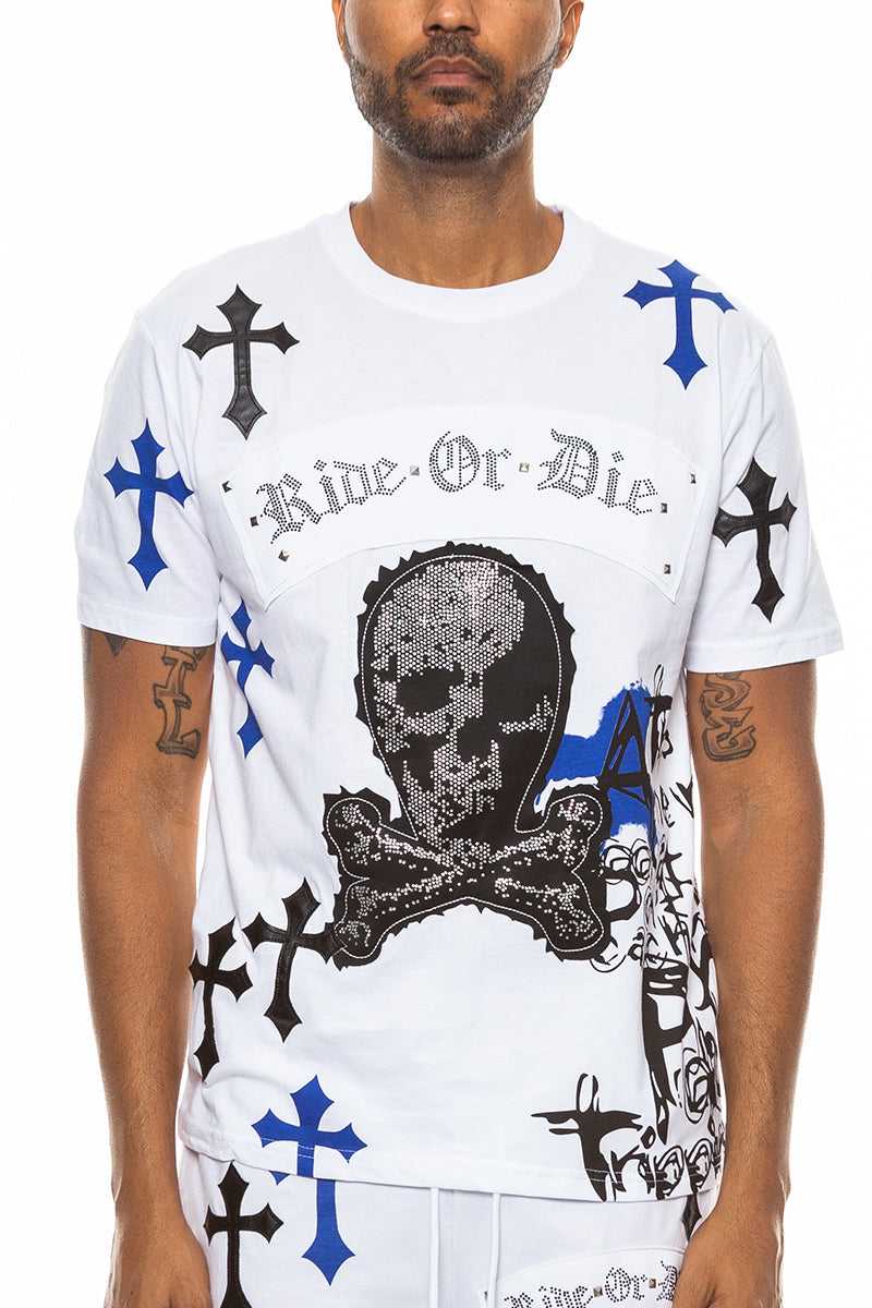 Man wearing a white t-shirt with black and blue designs and text on a white background